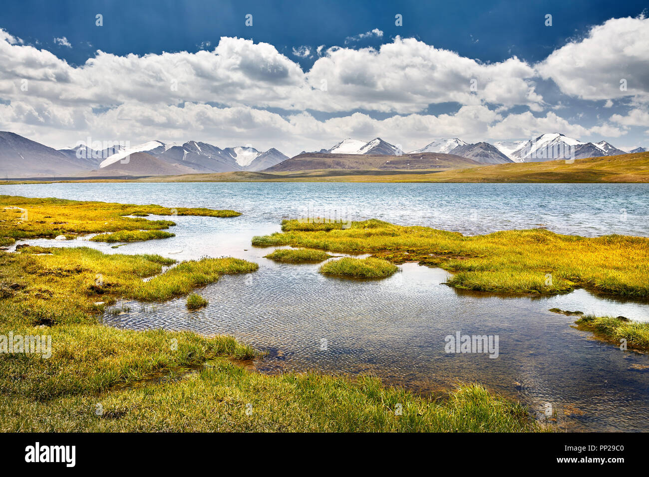 Mountain Lake in the valley against cloudy sky in Kyrgyzstan Stock Photo