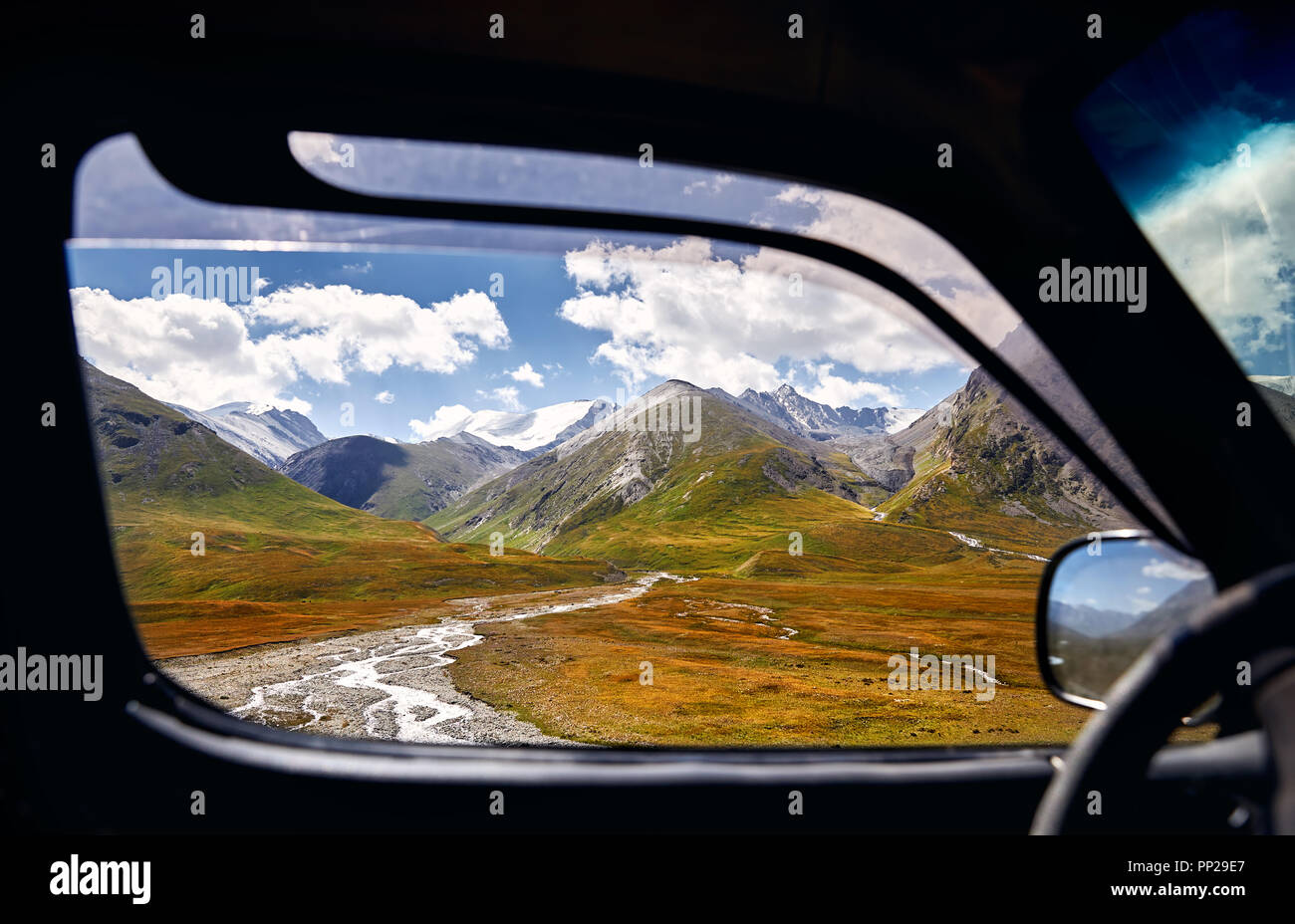 Landscape of beautiful mountain valley viewed from the car window. Travel and adventure concept. Stock Photo