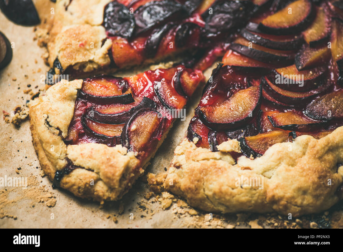 Plum galetta sweet cake dessert on baking paper, horizontal composition Stock Photo