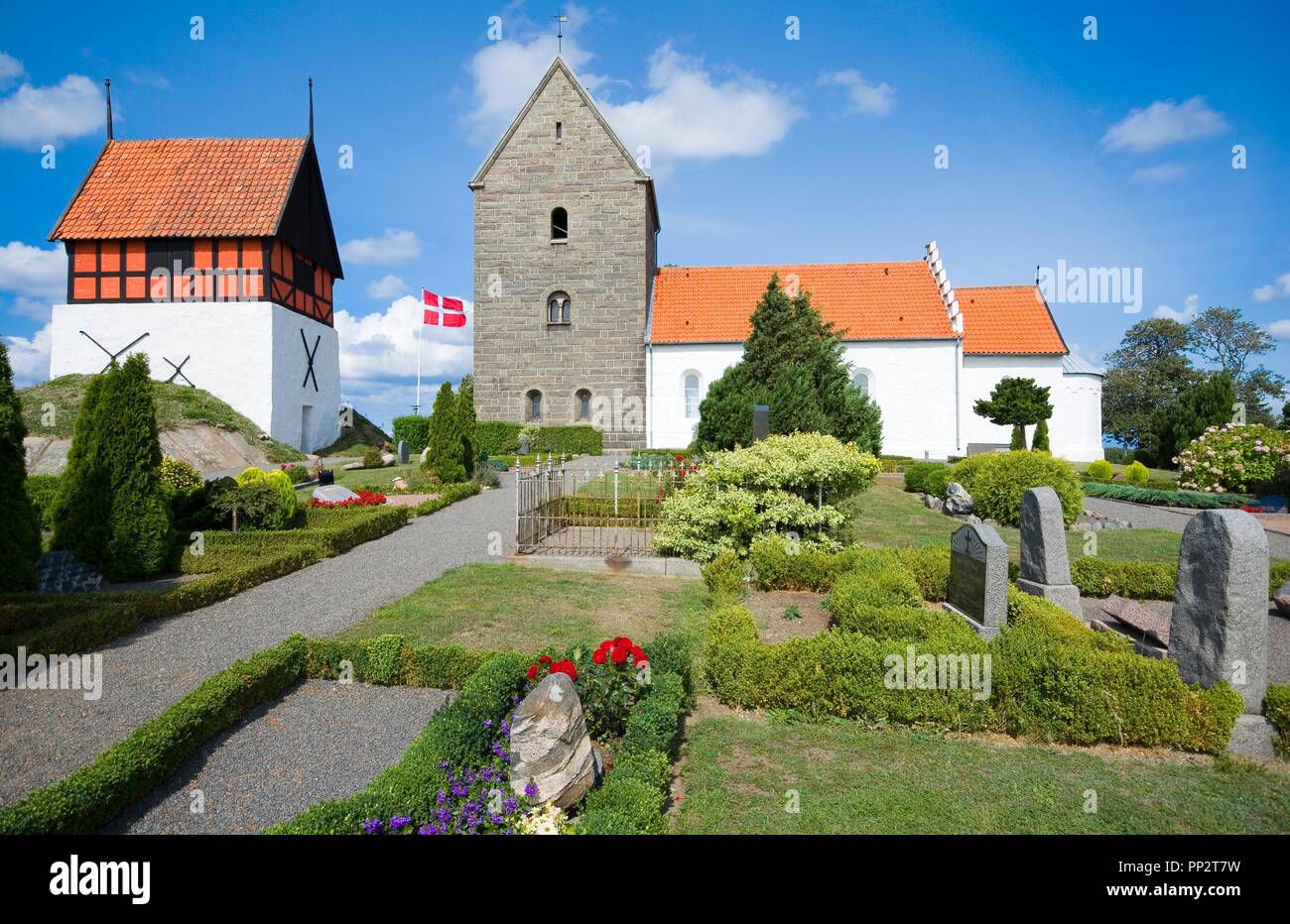 RUTSKER, DENMARK - AUGUST 25, 2018: View of the Church of Ruth from the graveyard. Built about 1200, is the highest point for a church anywhere in Den Stock Photo