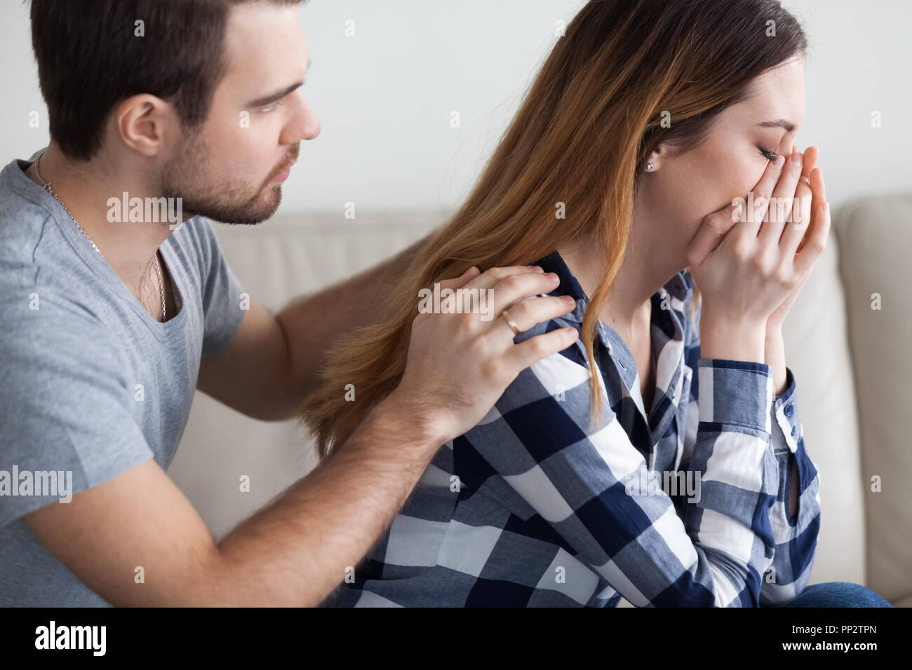 Caring man comfort crying wife making peace after fight Stock Photo