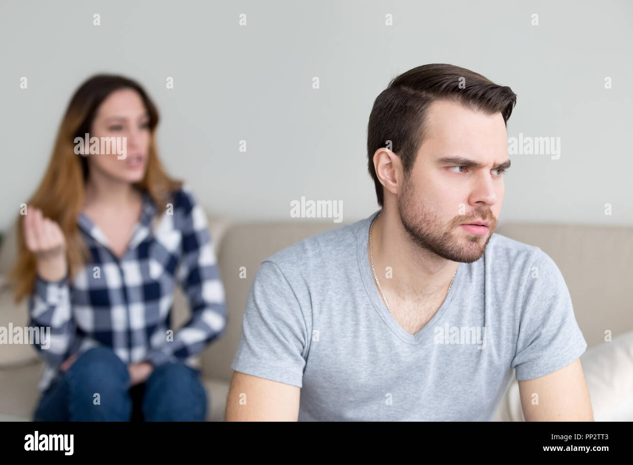 Annoyed husband tired of wife lecturing and arguing Stock Photo