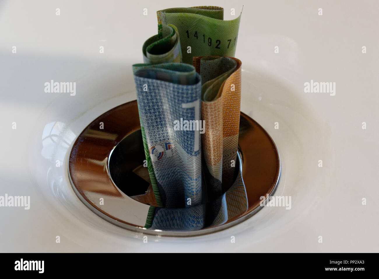 Throw Money Down The Drain High Resolution Stock Photography and Images