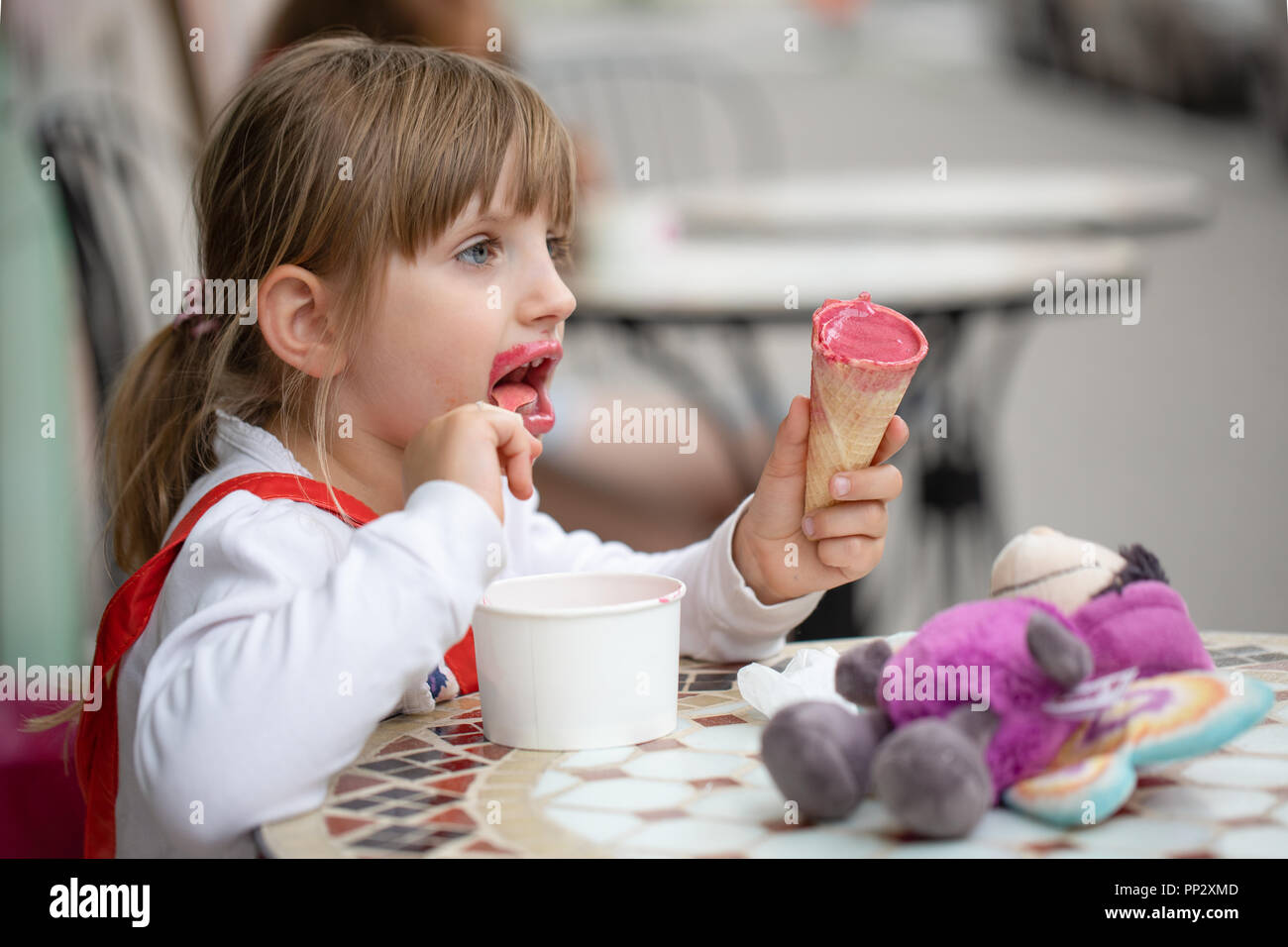 Cute Little Girl Eating Ice Cream Stock Photo Alamy