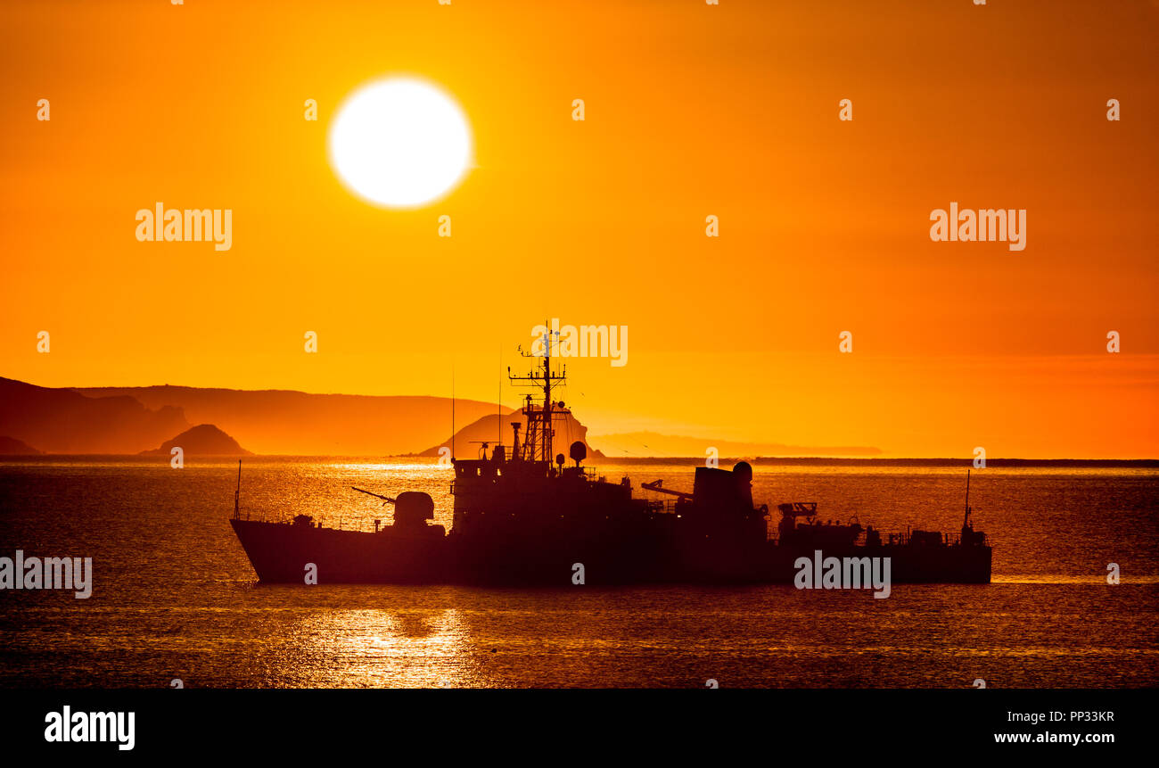 Kinsale, Cork, Ireland. 19th May 2017. Naval patrol vessel L.É. Orla  silhouetted against the rising Sun at the Old Head of Kinsale, Cork, Ireland. Stock Photo