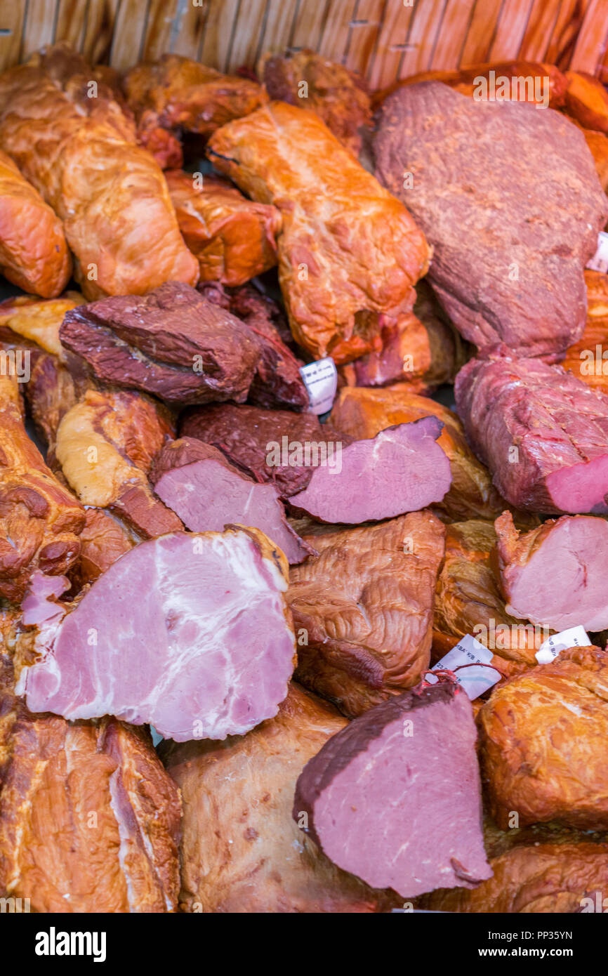 Deli display cold meat and salami. Smoked meat on shop window in store