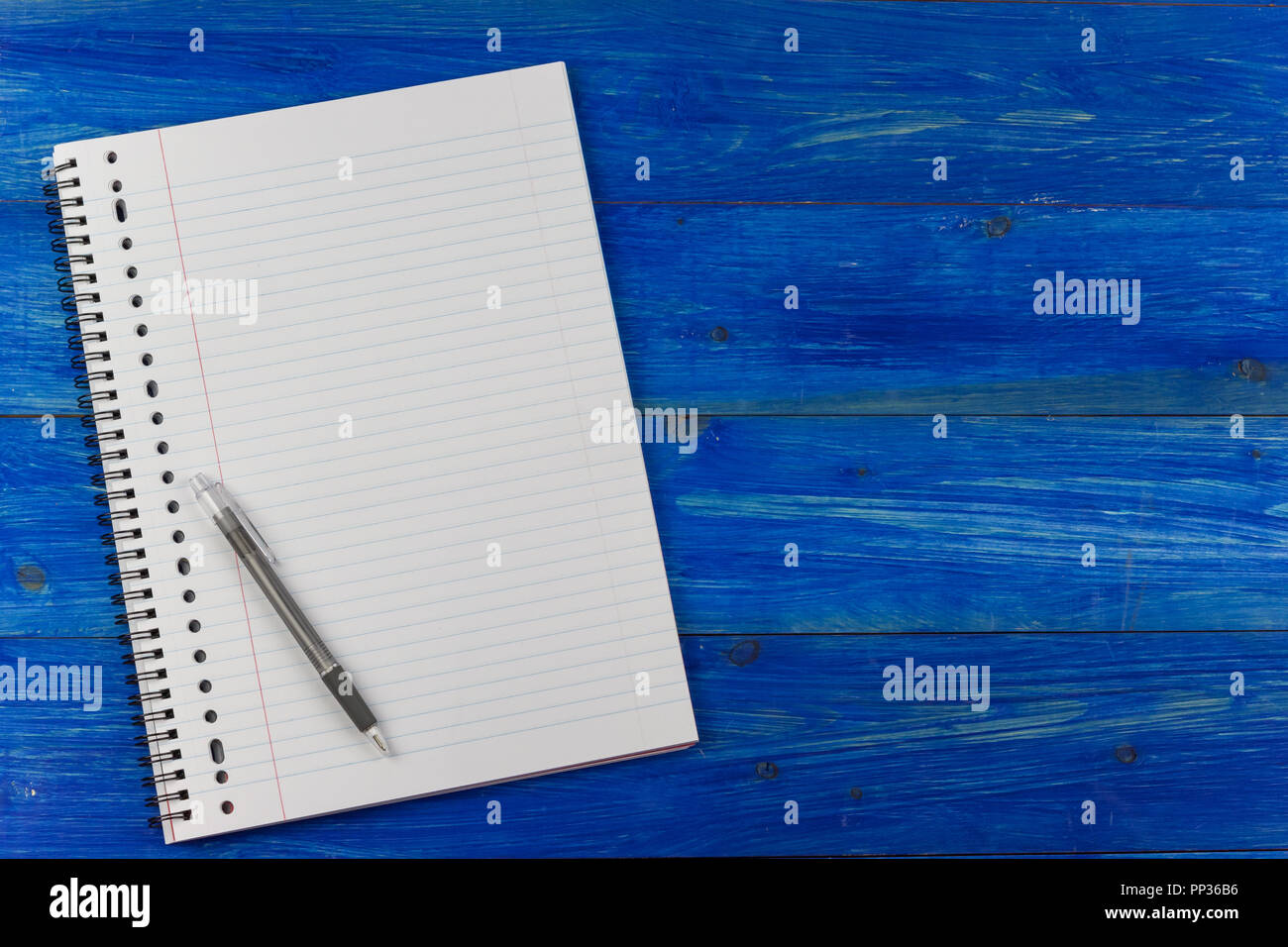 Notepad and pen on a blue wooden table Stock Photo