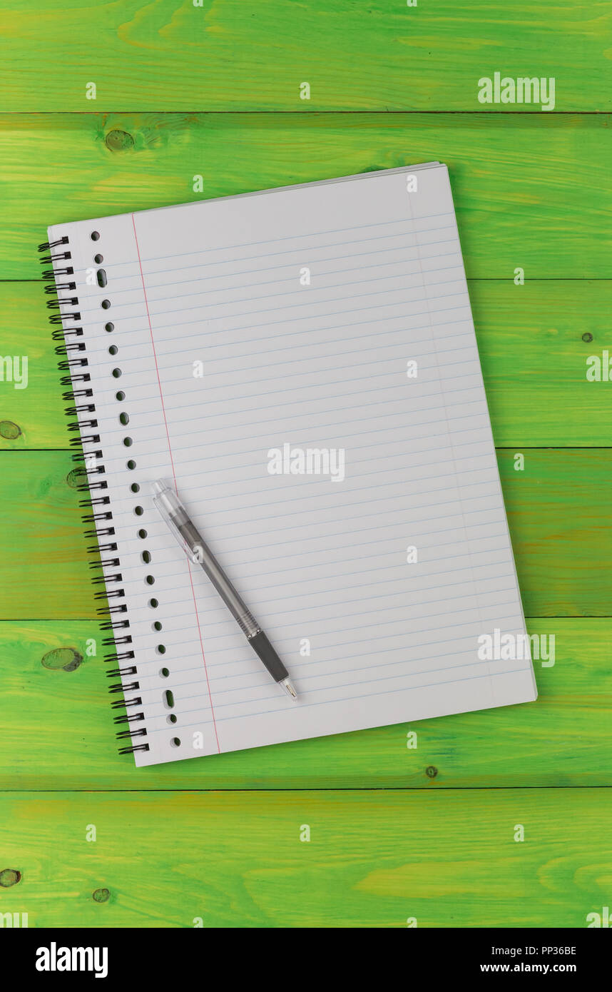 Notepad and pen on a green wooden table Stock Photo - Alamy
