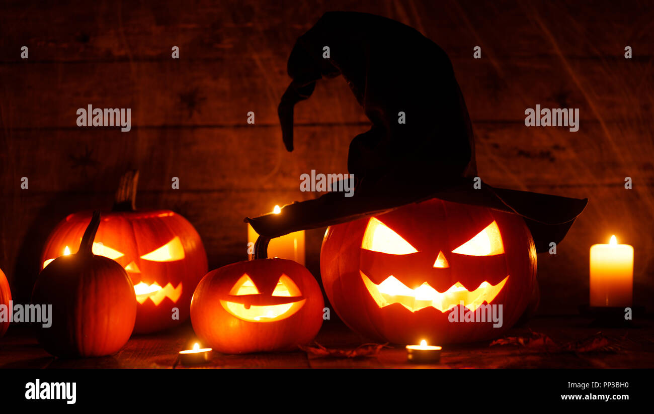 Jack O Lantern Halloween pumpkins with witches hat and burning candles ...
