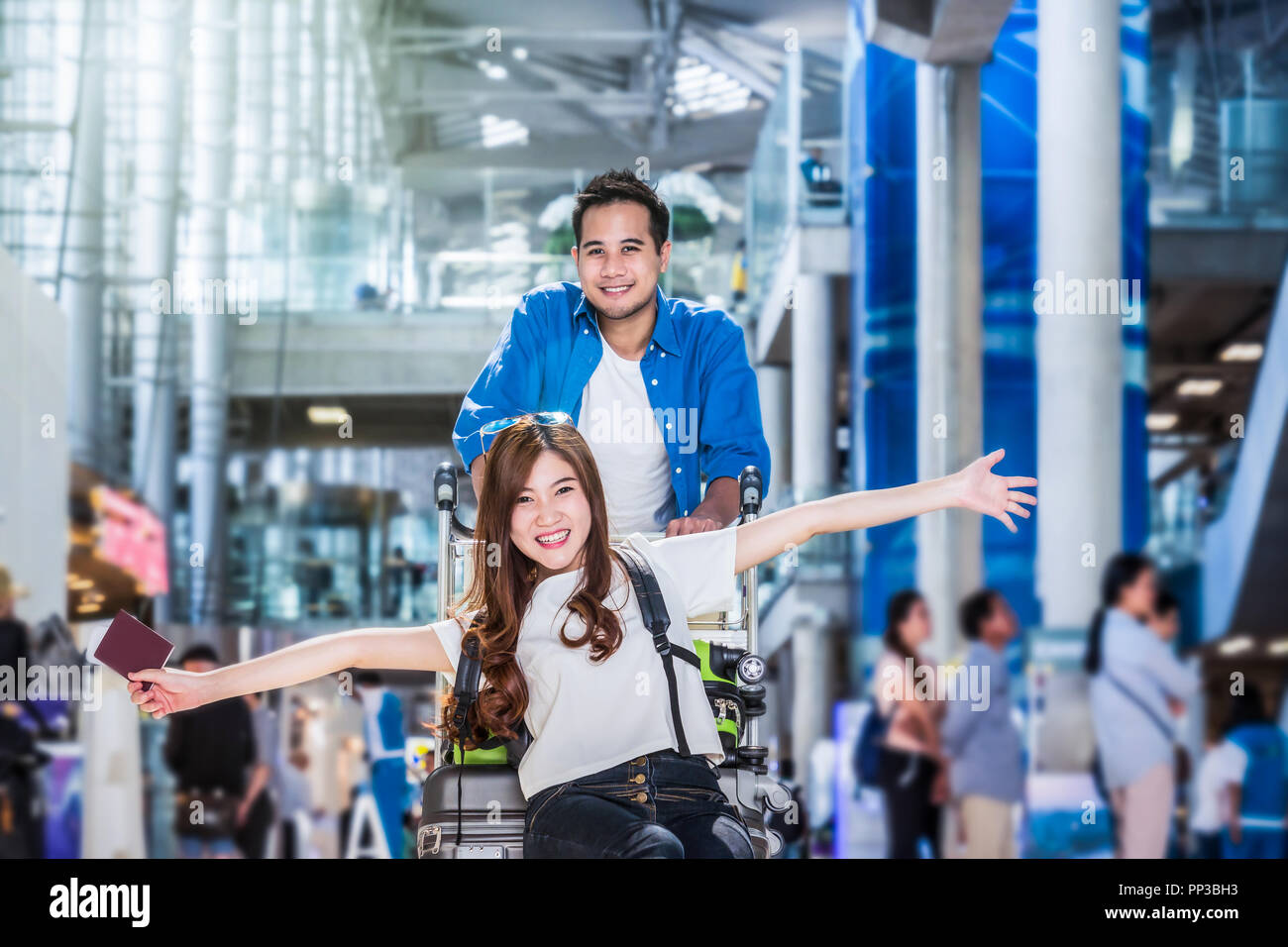 Asian couple traveler with suitcases at the airport. Lover travel and transportation with technology concept. Stock Photo