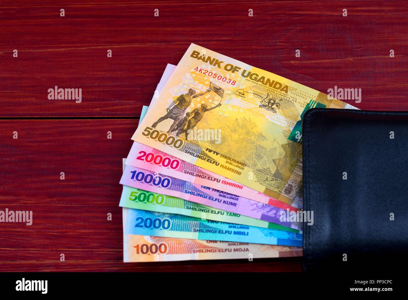 Ugandan Shilling in the black wallet Stock Photo