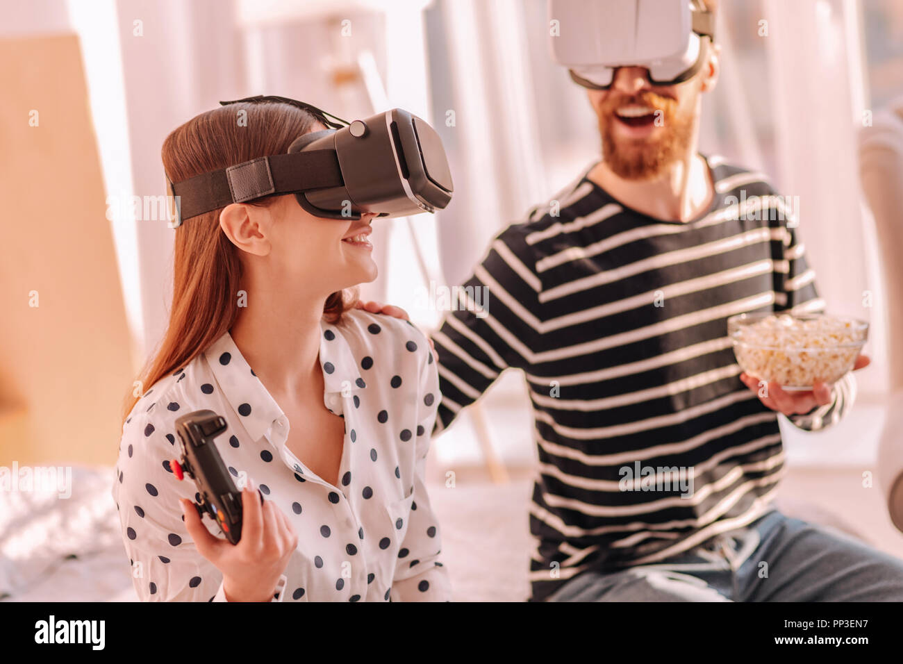 Nice young couple playing video games together Stock Photo