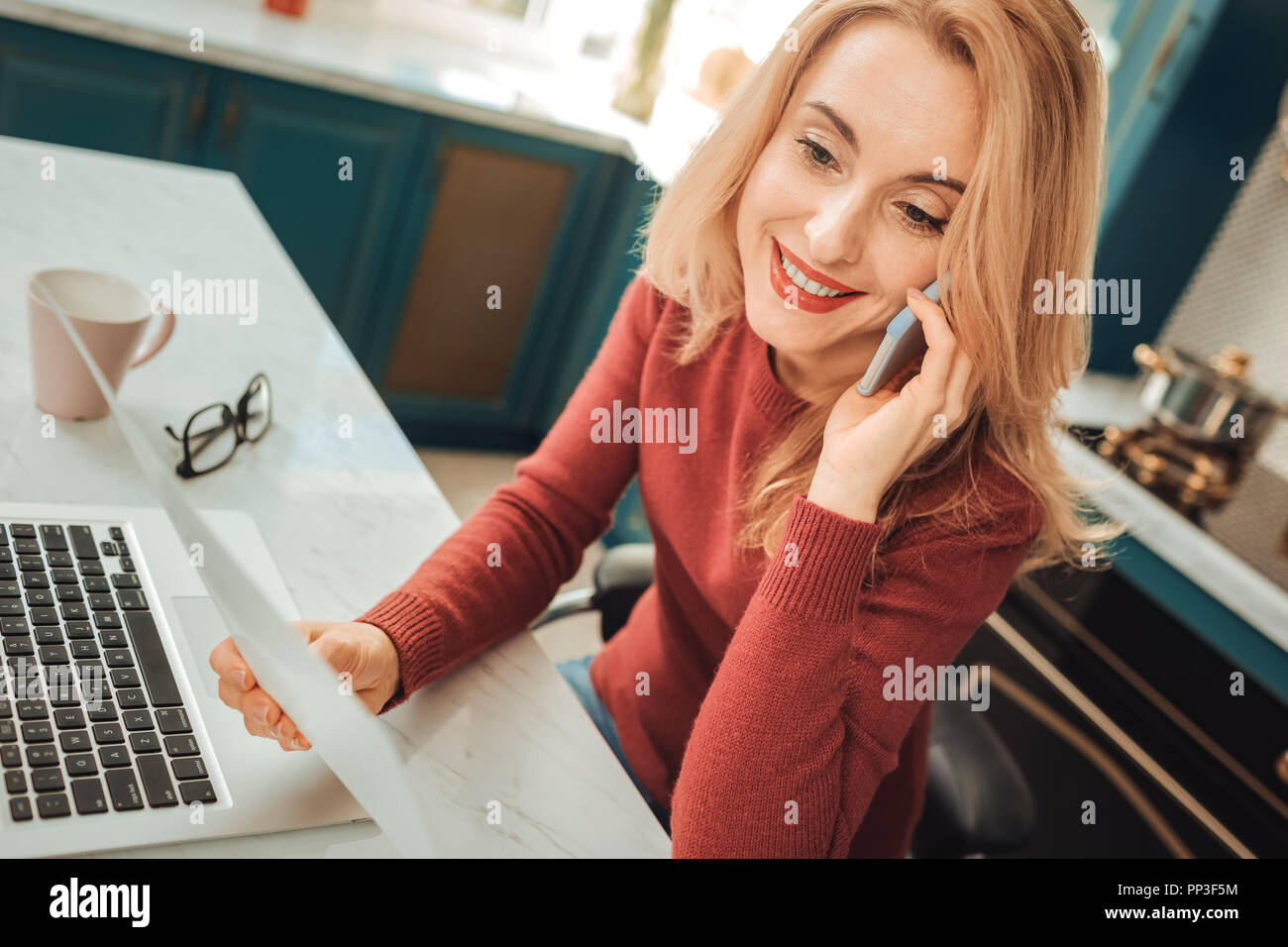 Pleased female person enjoying her interaction at work Stock Photo - Alamy