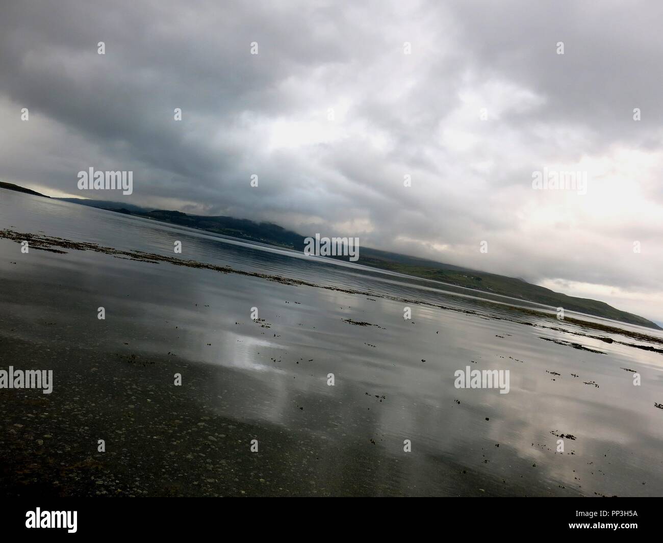 Cloudy sky reflected on water, low tide, Isle of Skye, Scotland. Stock Photo