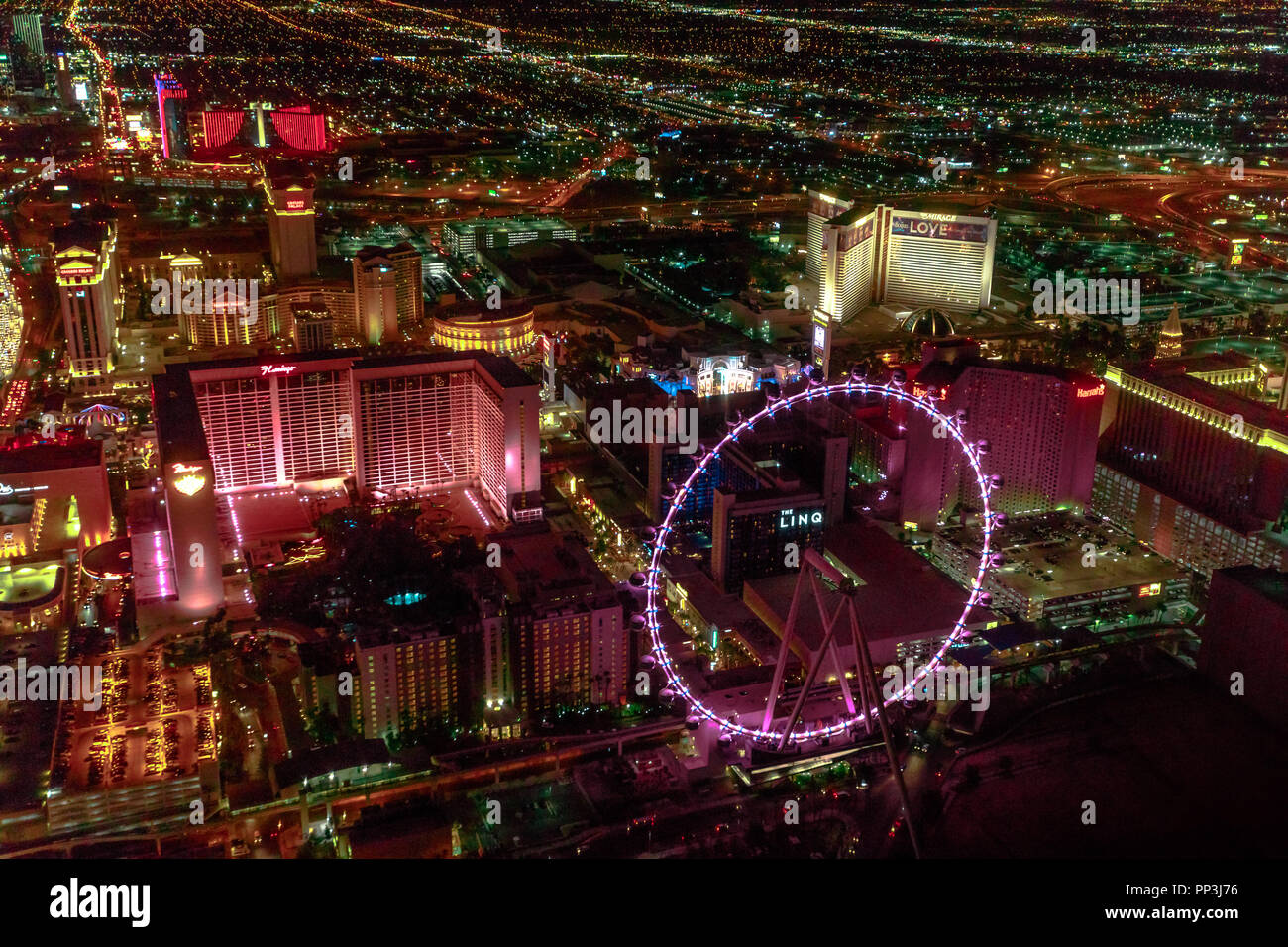 Las Vegas, Nevada, United States - August 18, 2018: aerial view of Las Vegas Strip Skyline illuminated by night. Scenic flight above: High Roller, The Linq, The Mirage and Flamingo Casino and Hotel. Stock Photo