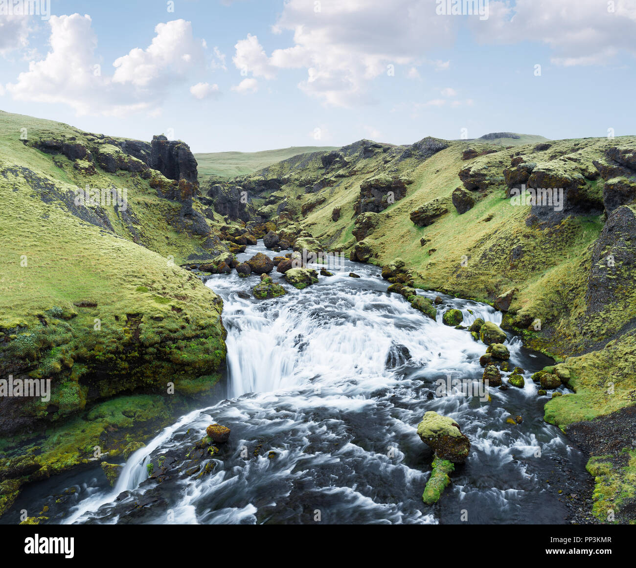 Green gorge with moss and the river Skoga. Beautiful cascades. The amazing nature of Iceland Stock Photo
