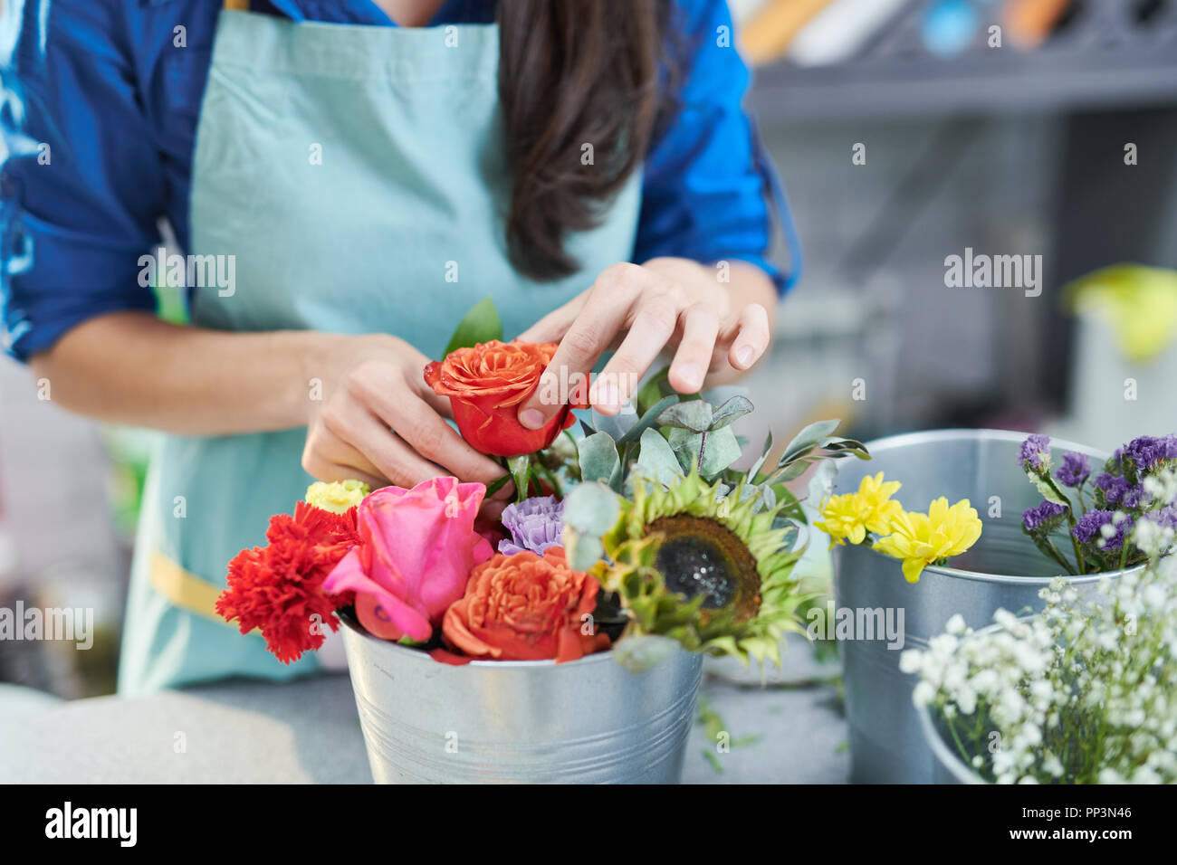 Young Woman Arranging Rose Composition Stock Photo