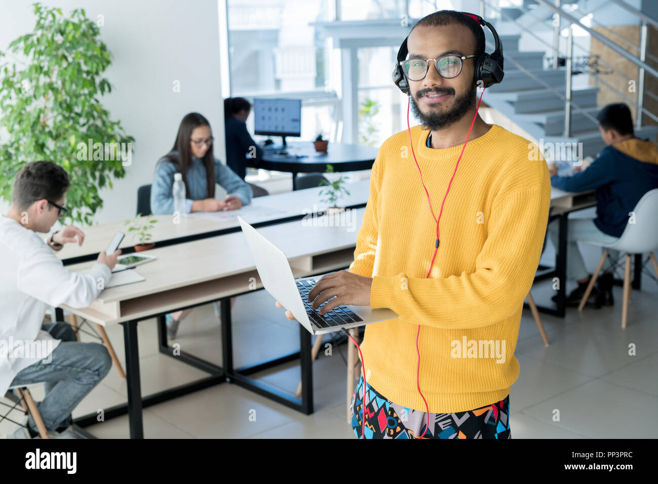 Male designer using laptop Stock Photo