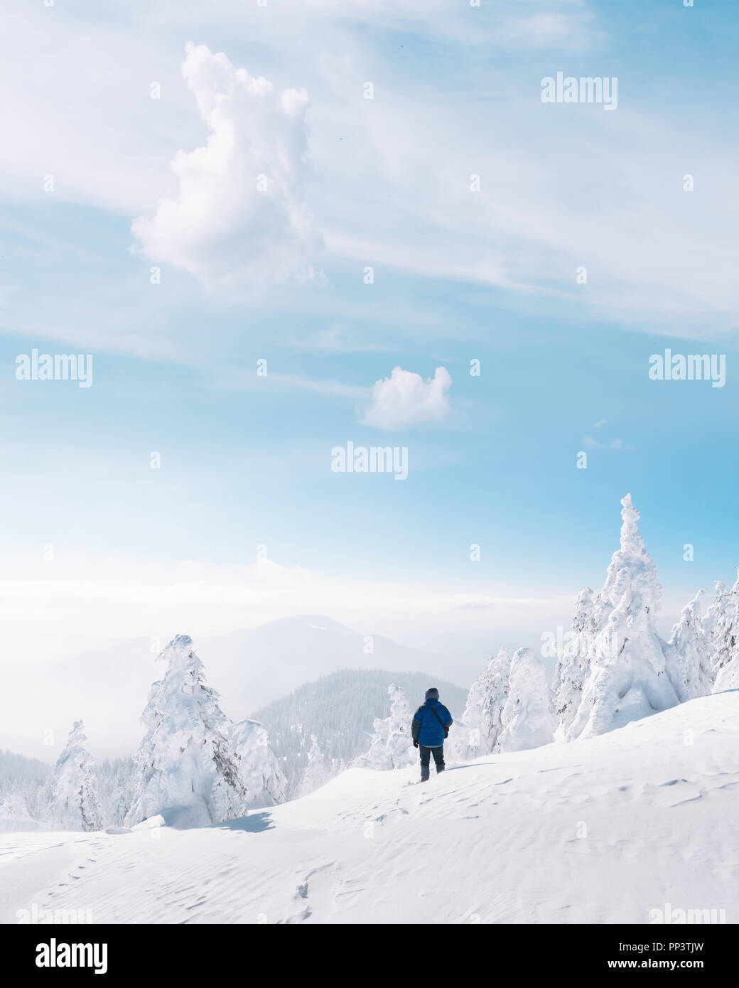 Alone tourist with a backpack in the high mountains in winter time. Travel concept Stock Photo