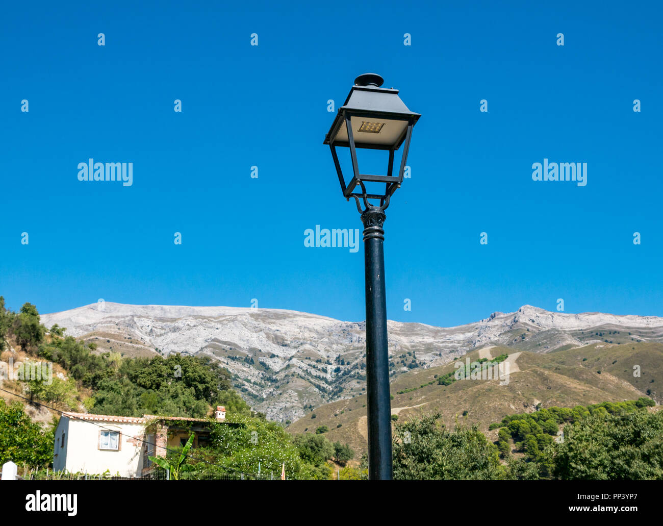 Looking up at streetlight against folded mountain cliff, Sierras de Tejeda Natural Park, Sedella, Axarquia, Andalusia, Spain Stock Photo