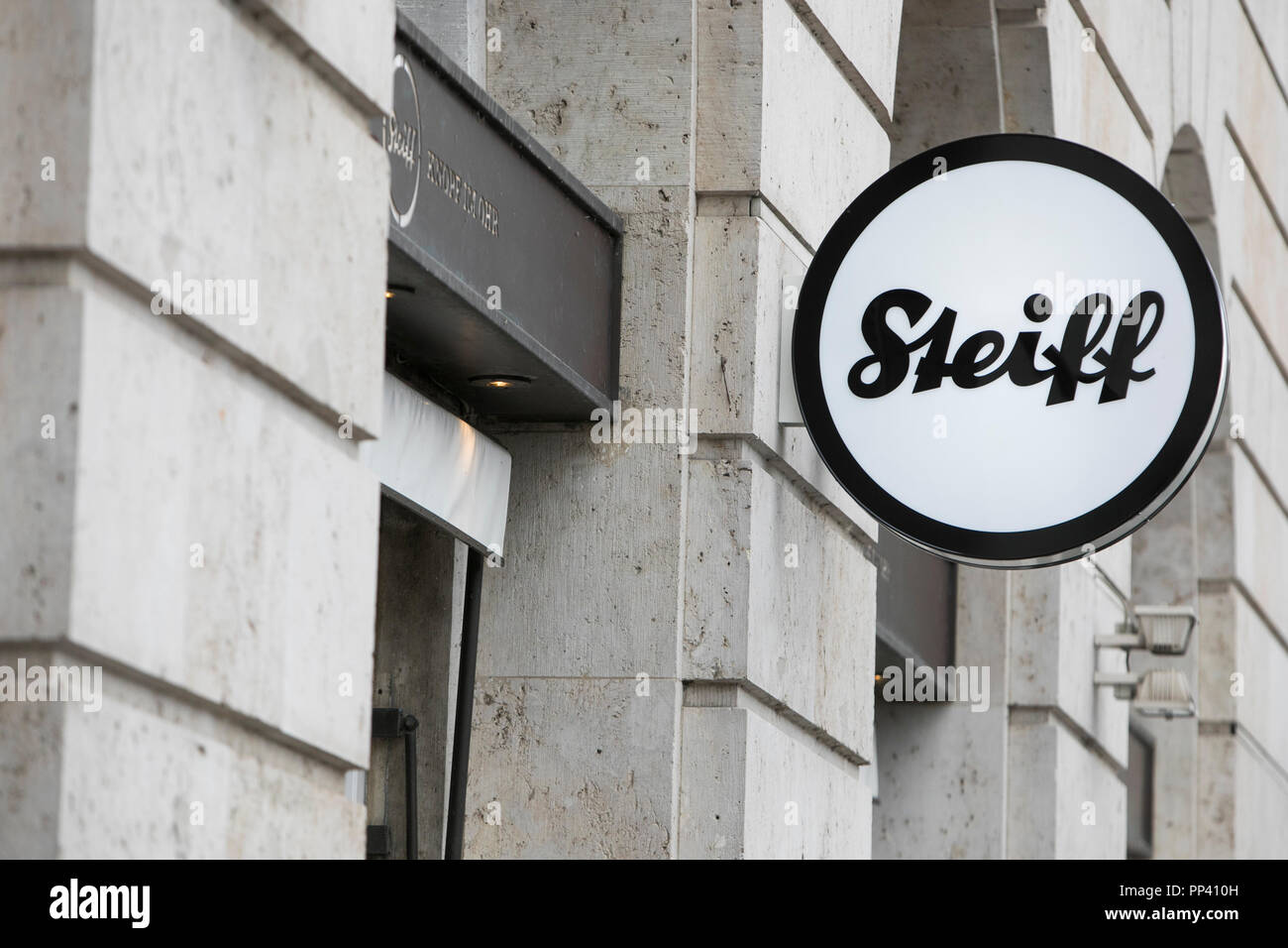 A logo sign outside of a Steiff retail toy store in Munich, Germany on