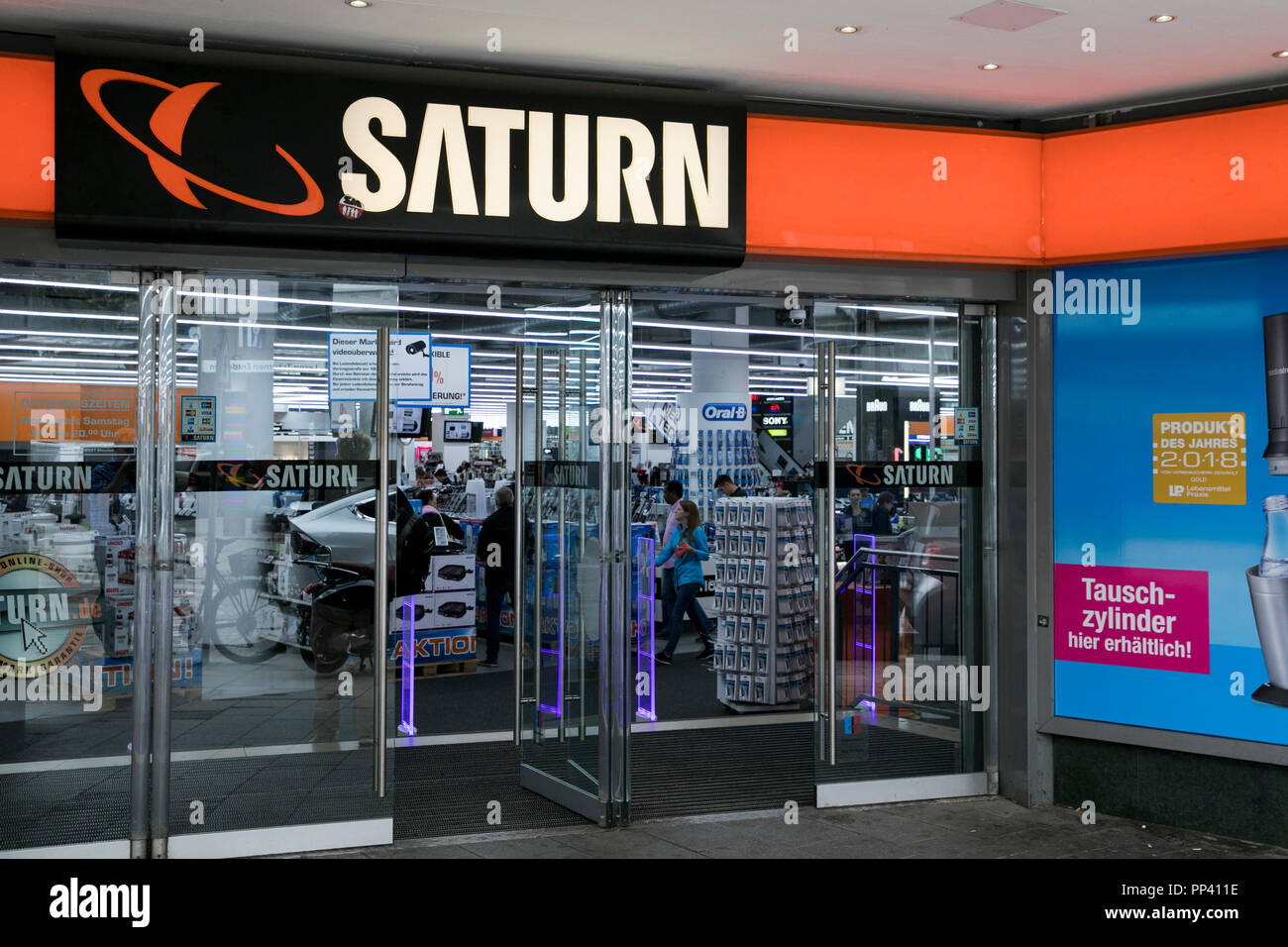 A logo sign outside of a Saturn retail store in Munich, Germany, on August 25, 2018. Stock Photo