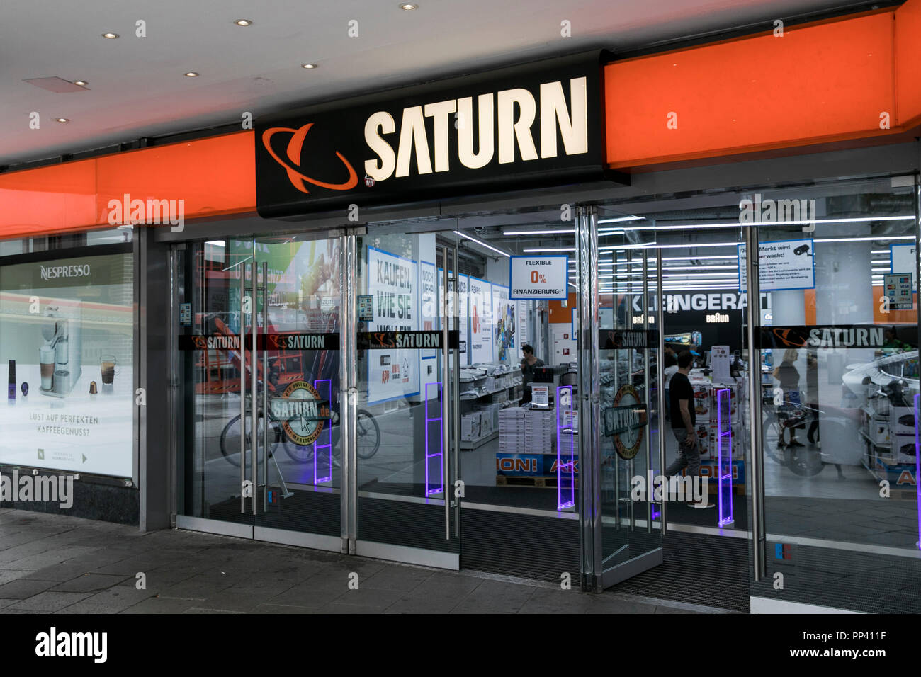 A logo sign outside of a Saturn retail store in Munich, Germany, on August 25, 2018. Stock Photo