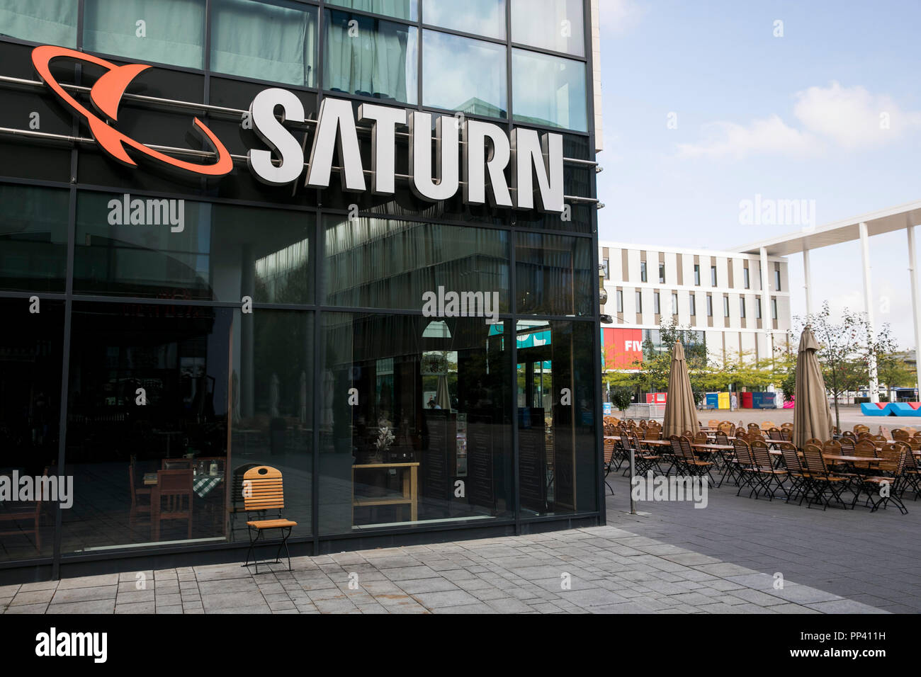 A logo sign outside of a Saturn retail store in Munich, Germany, on August 26, 2018. Stock Photo