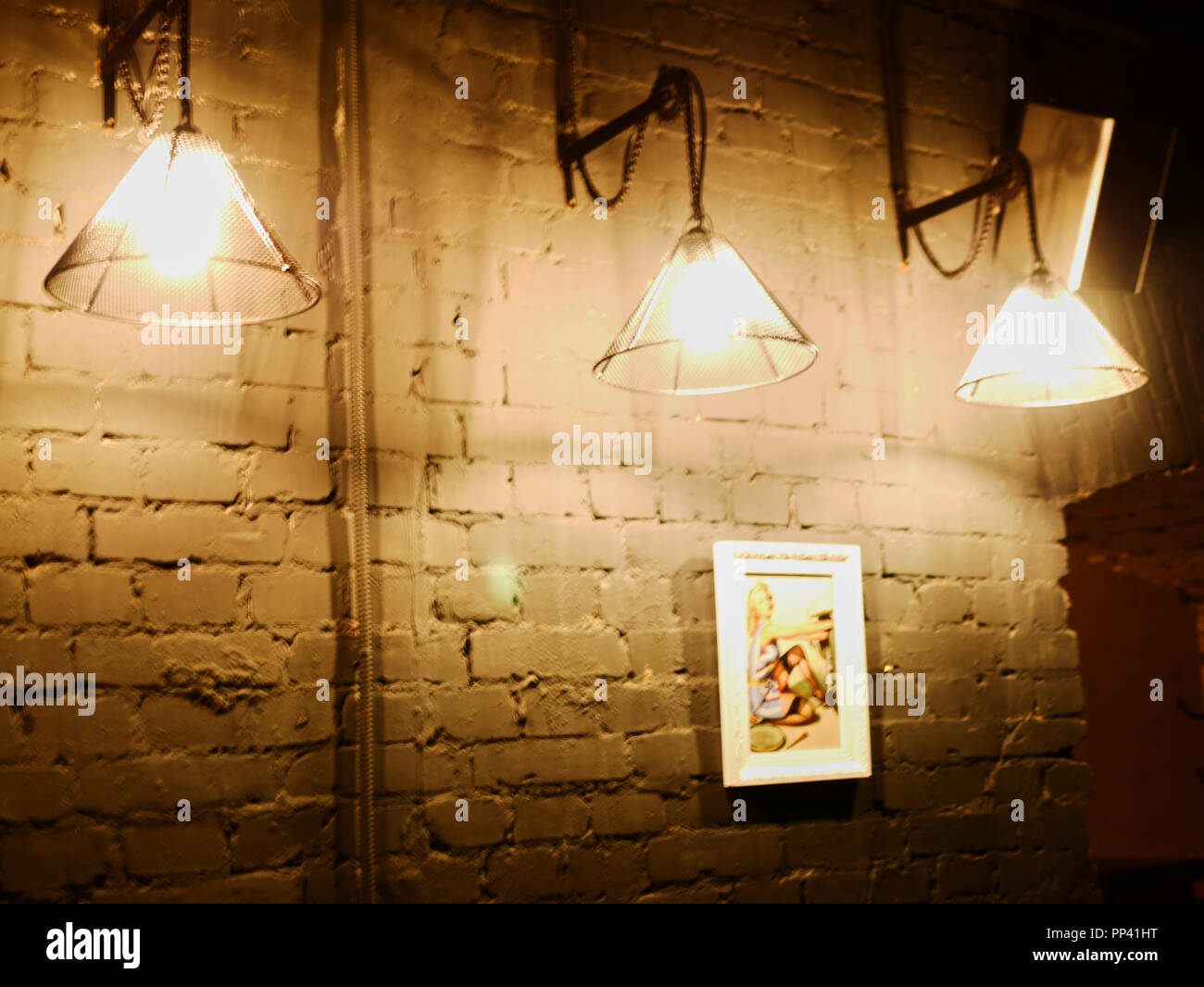 Vintage lighting lamp hang in front of cement brick wall at loft. Stock Photo