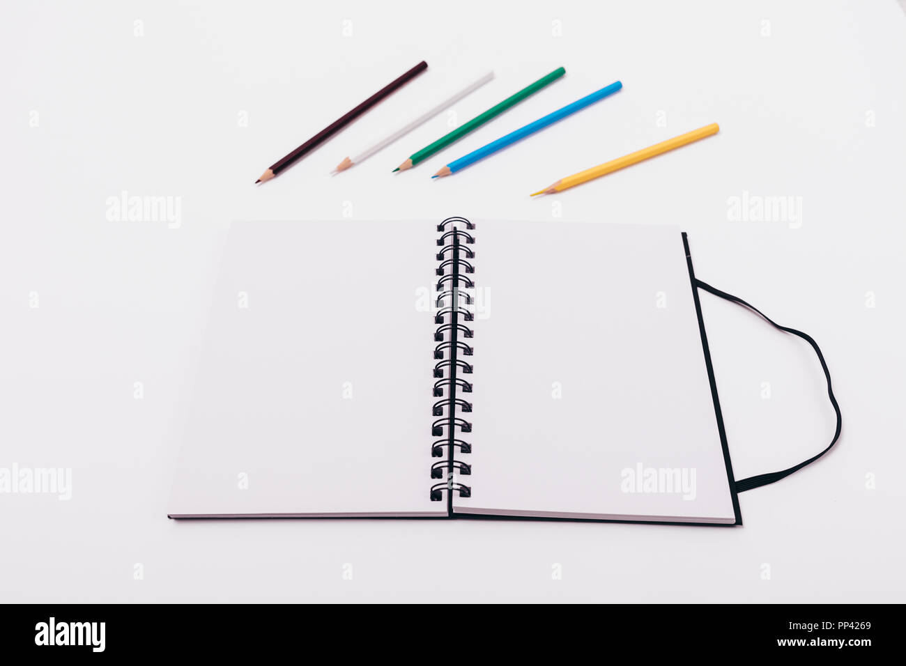 Premium Vector  Blank page of notebook, sketchbook, album. pencils are  near the notebook