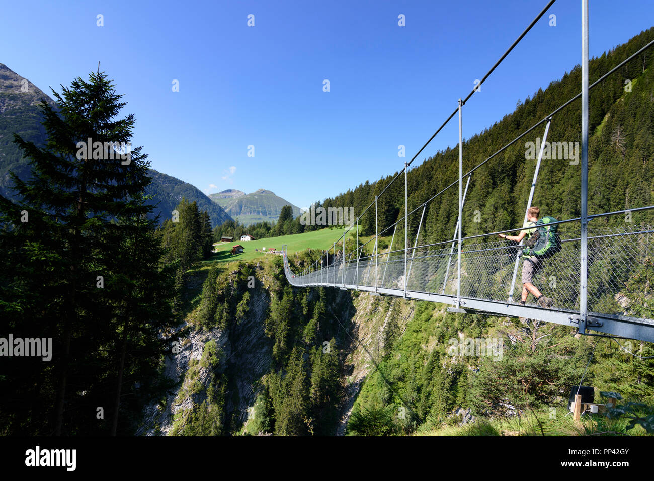 Holzgau: Hängebrücke (suspension bridge), hiker, Lechtal Valley, Tirol, Tyrol, Austria Stock Photo