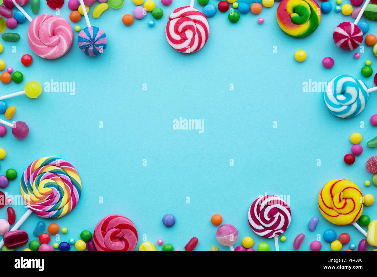 Colorful candies on a blue background Stock Photo - Alamy