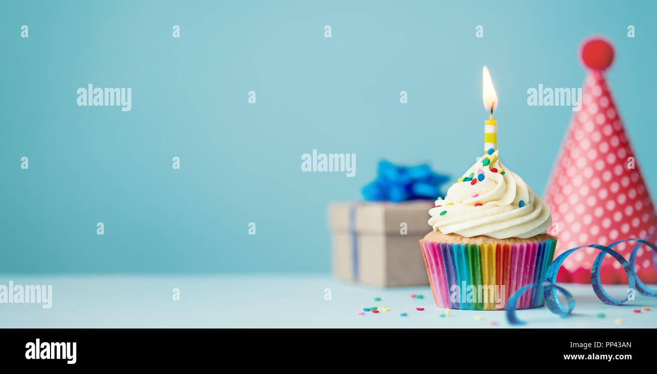 Birthday party background with cupcake, party hat and present Stock Photo