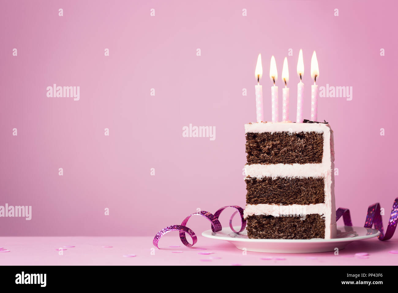 Chocolate birthday cake with pink frosting and candles Stock Photo - Alamy