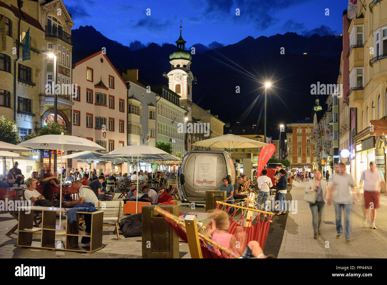 Innsbruck: street Maria-Theresien-Straße, church Spitalskirche, people at reading festival, mountain Nordkette, Region Innsbruck, Tirol, Tyrol, Austri Stock Photo