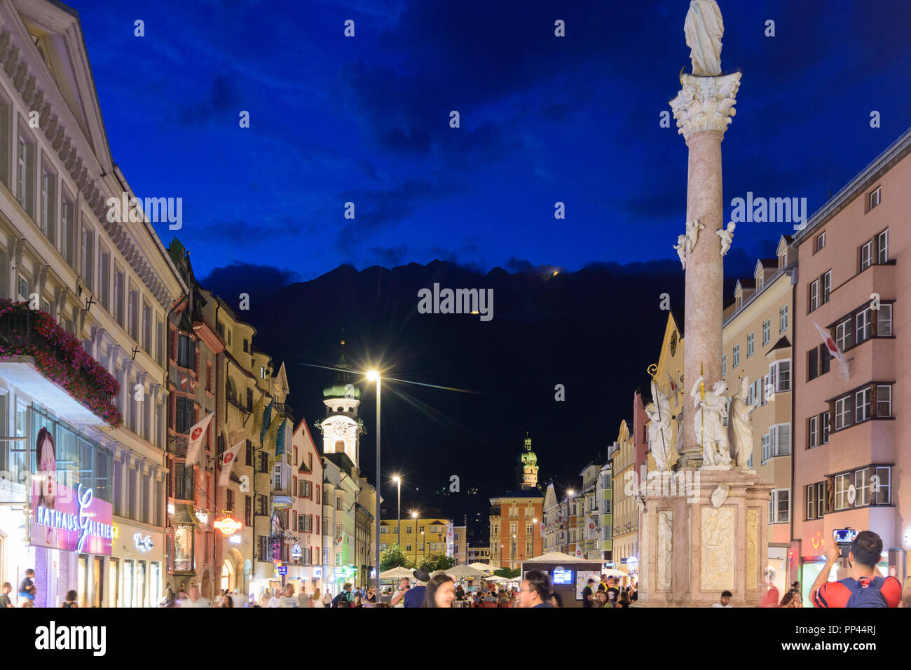 Innsbruck: street Maria-Theresien-Straße, column Annasäule, church Spitalskirche, mountain ...
