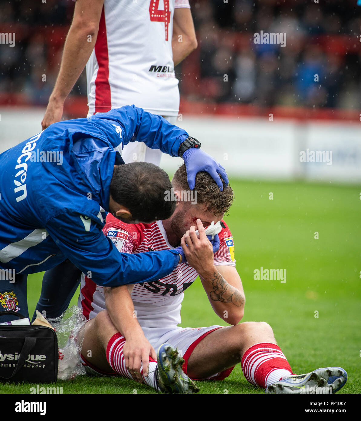 Football / soccer player receiving treatment for injury of cut above