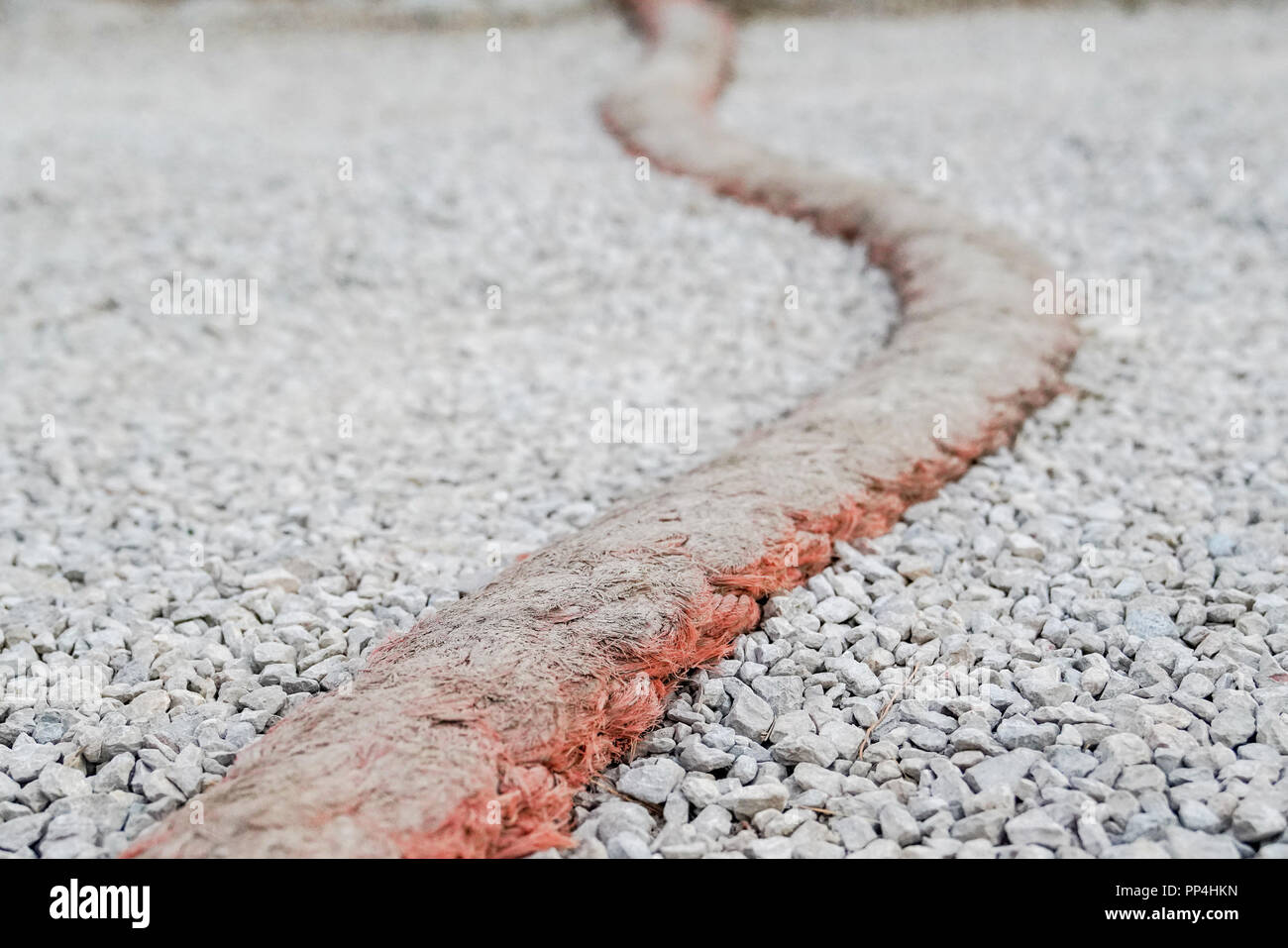 Rope as a speed bump on a gravel road Stock Photo - Alamy