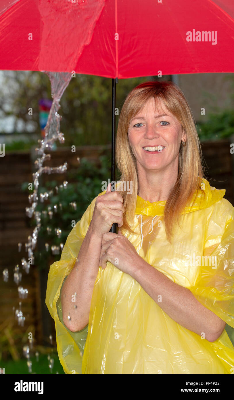 Girl holding yellow umbrella hires stock photography and images Alamy