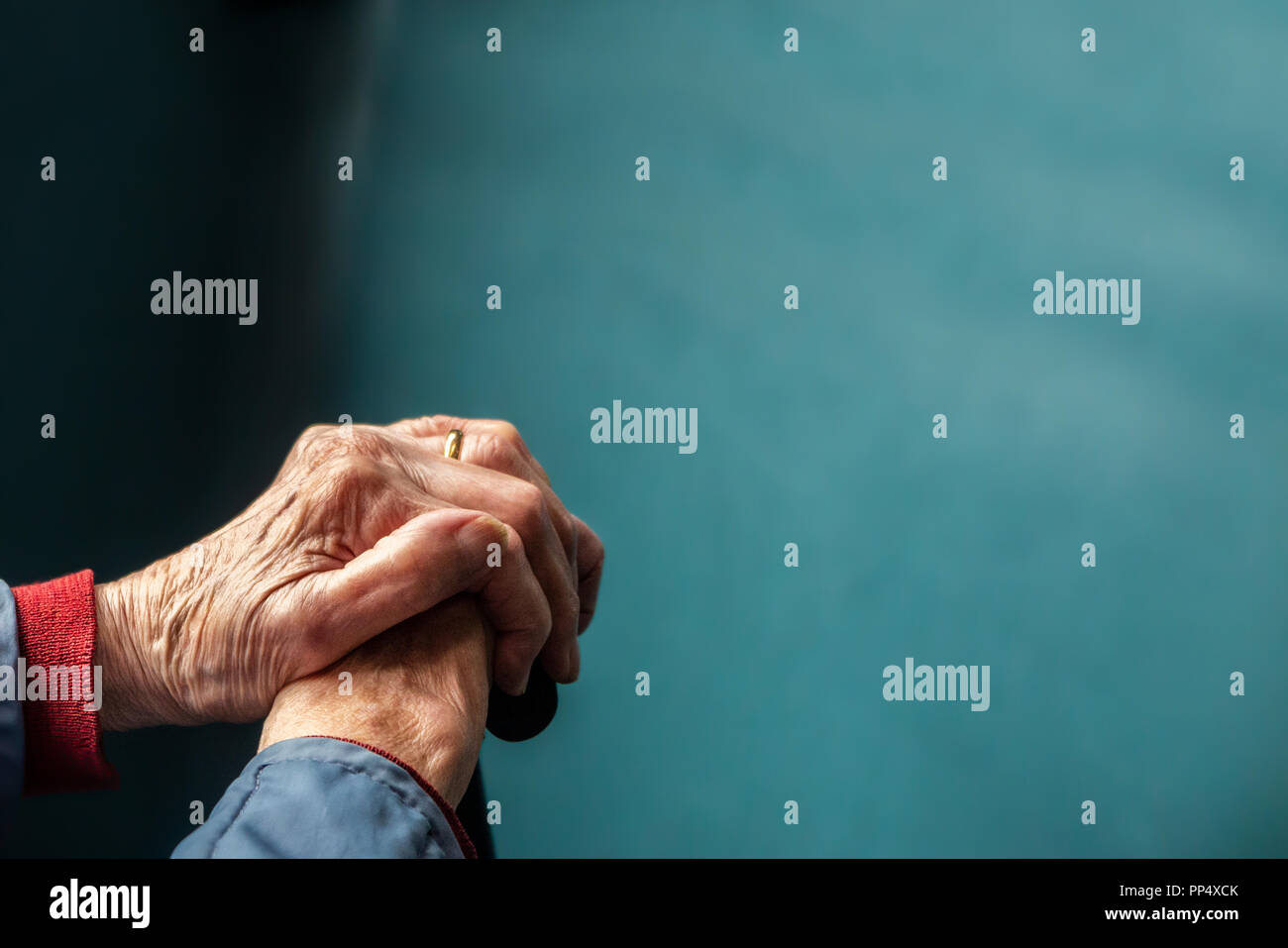 A portrait of an old lady's hands clutching a walking stick Stock Photo