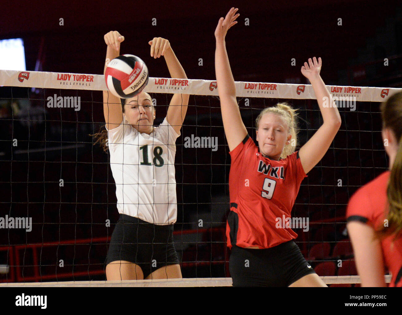 September 23, 2018 Charlotte 49er's Jocelyn Stoner middle blocker (18) spikes the ball past Western Kentucky Hilltoppers setter Taylor Bebout (9) during the first set in the match between the Charlotte 49er's and the Western Kentucky Hilltoppers at E.A. Diddle Arena in Bowling Green, KY. Photographer: Steve Roberts. Stock Photo