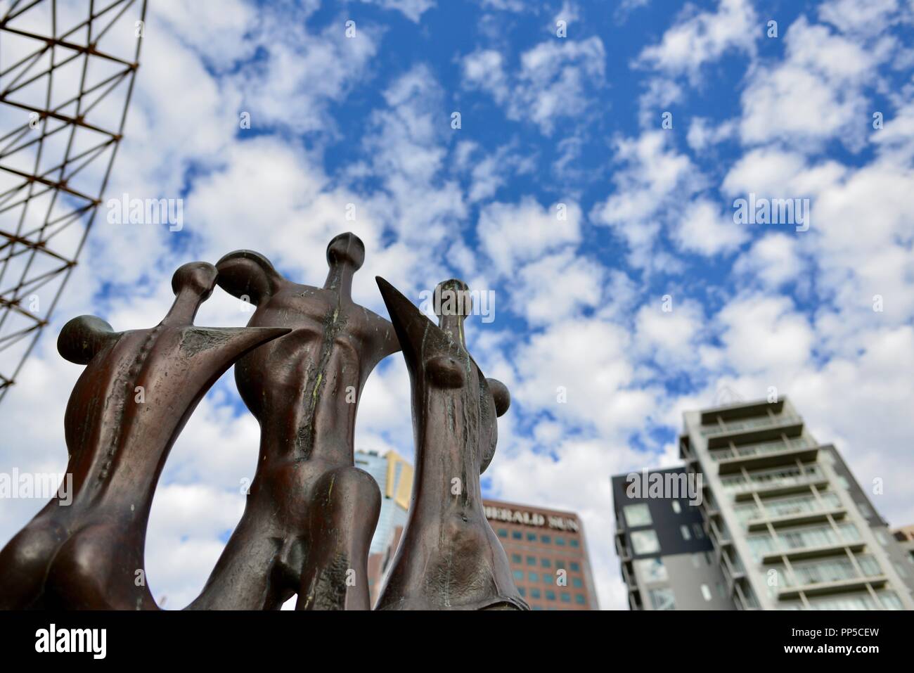 Brass sculptures at the State Theatre with a view of Melbourne in the background, Melbourne VIC, Australia Stock Photo