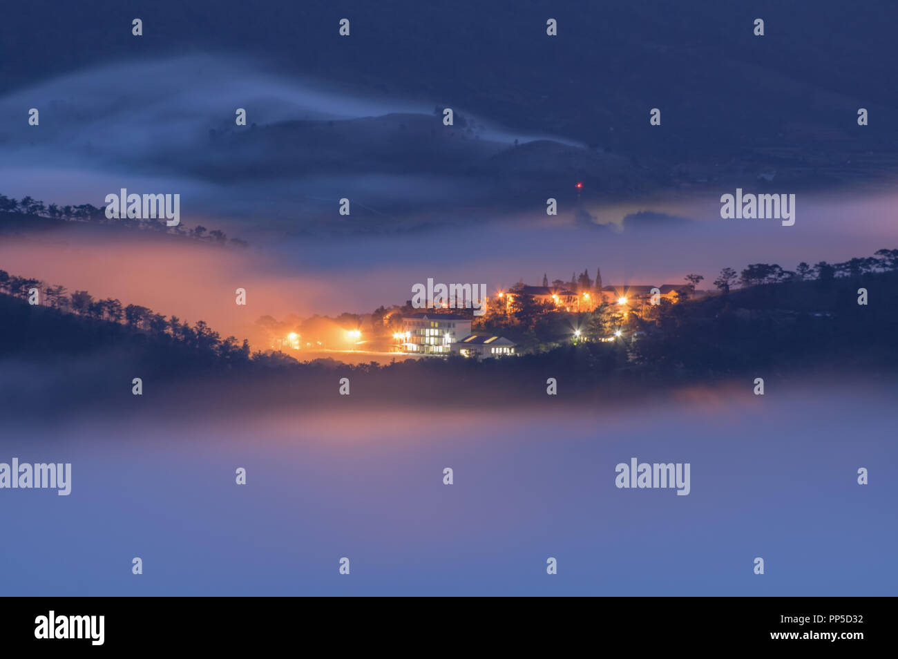 Long exposure with magic of the fog cover town and light at night, artwork of the landscape nature, pictures used in the design, advertising, travel, Stock Photo