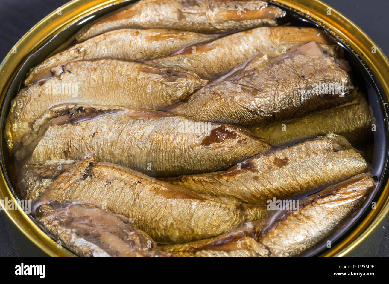 Canned fish. Smoked fish in an iron pot Stock Photo Alamy