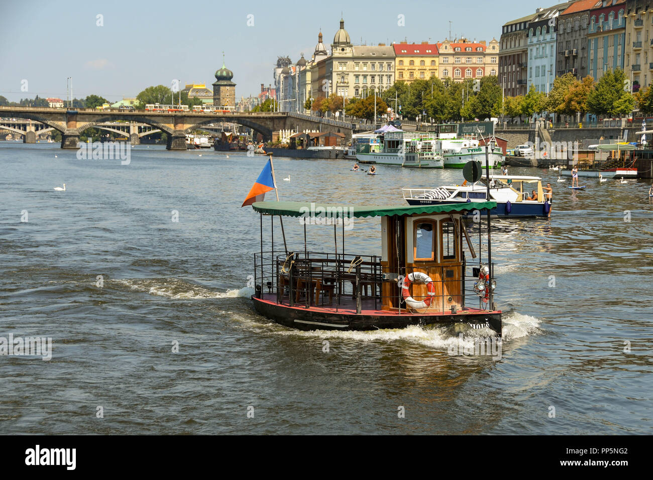 Small water taxi crossing the River Vltava in the centre of Prague Stock Photo