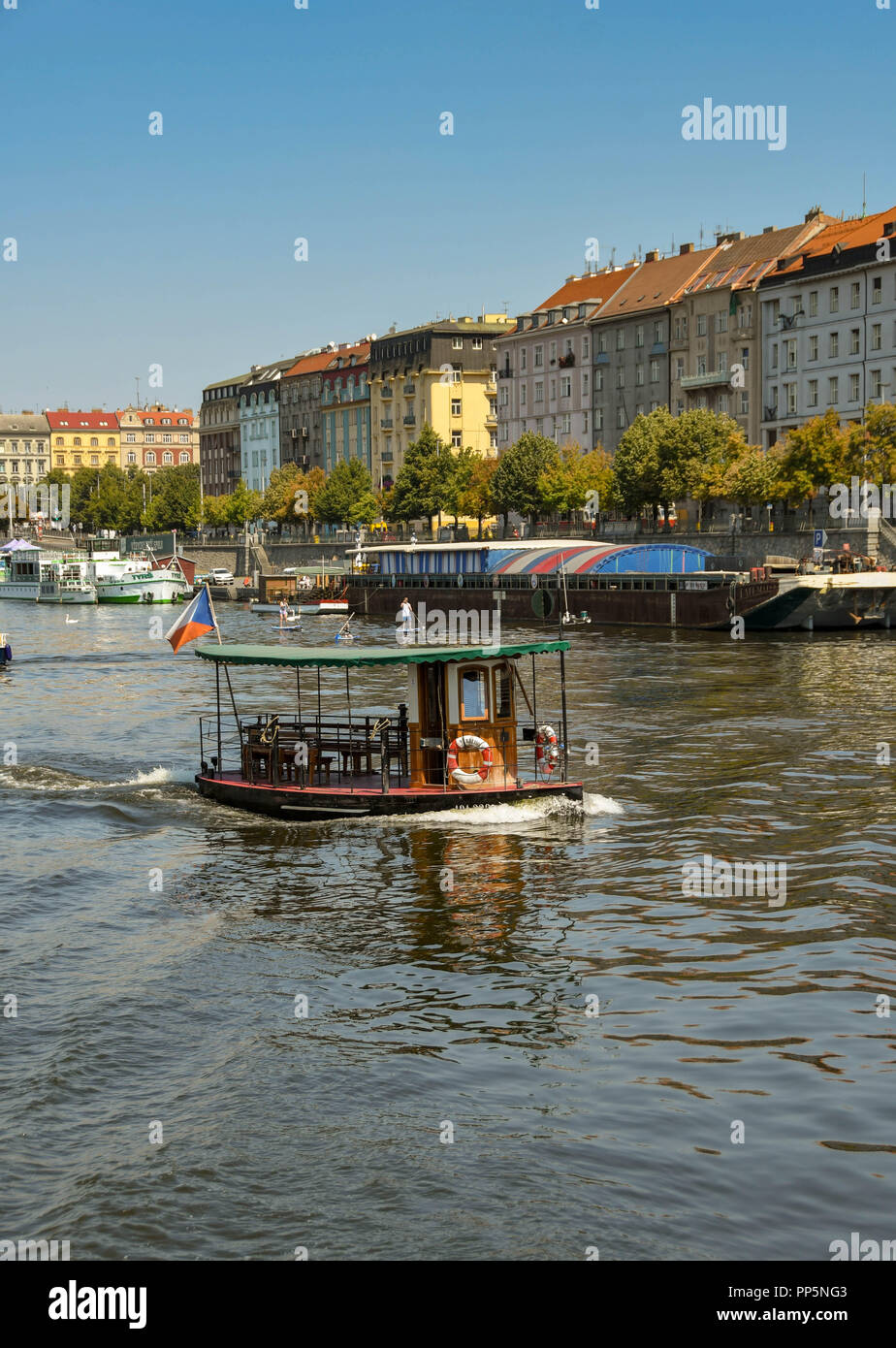 Small water taxi crossing the River Vltava in the centre of Prague Stock Photo