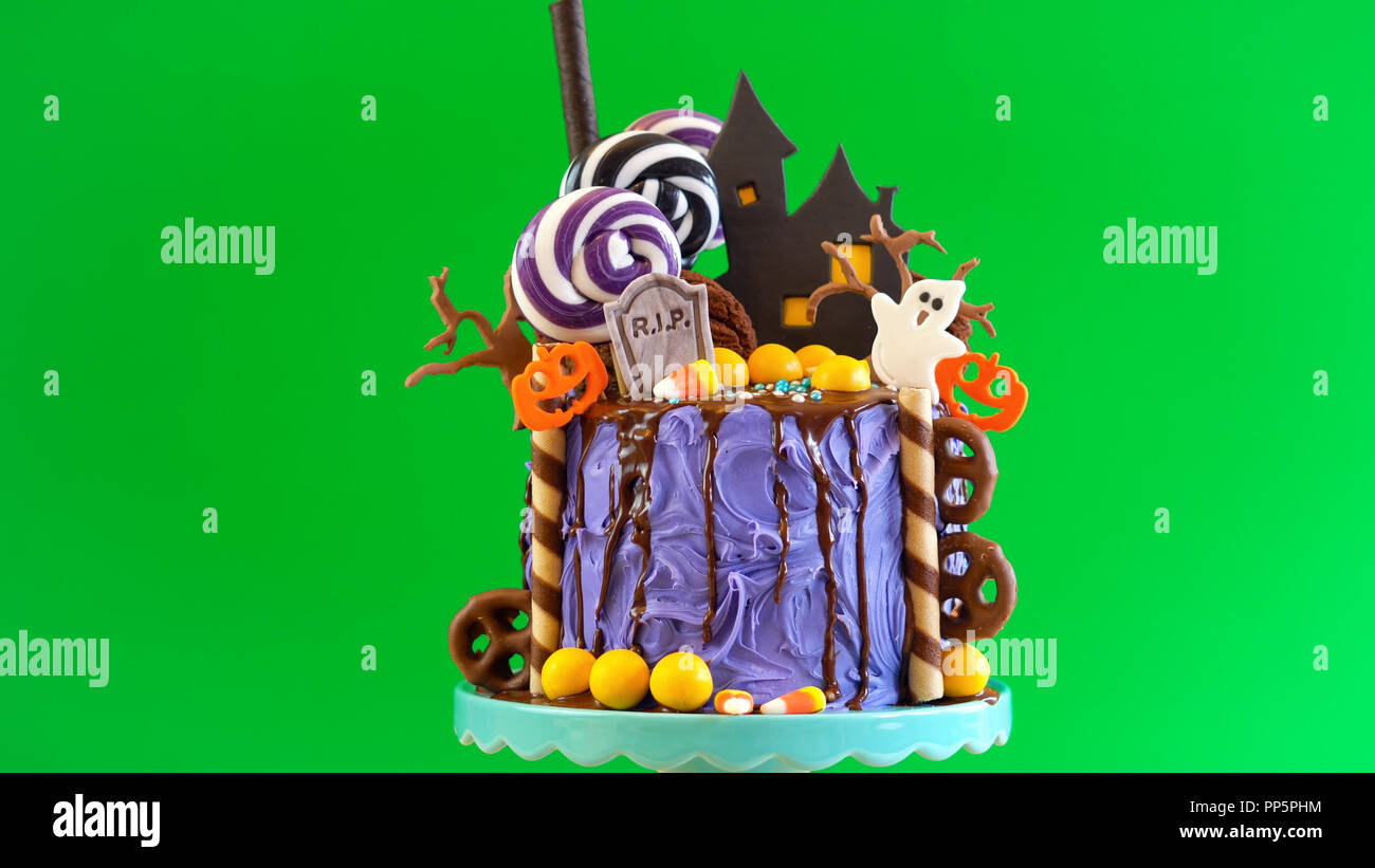 On Trend Halloween Candyland Fantasy Novelty Drip Cake And Party Table Against Chroma Key Green Background Stock Photo Alamy