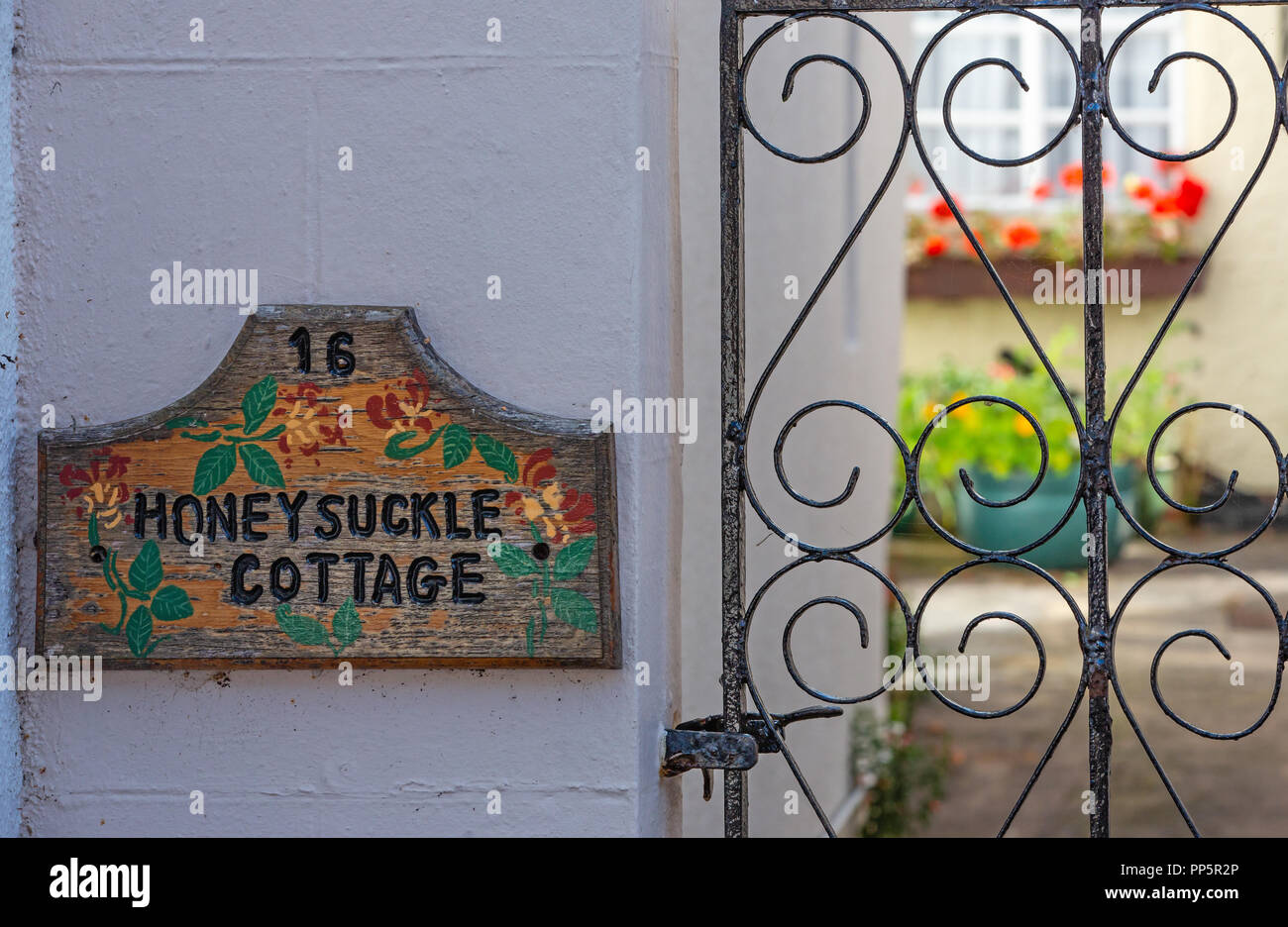 Wooden house sign, Honeysuckle cottage, leading into courtyard, Nether Stowey, Somerset, UK Stock Photo
