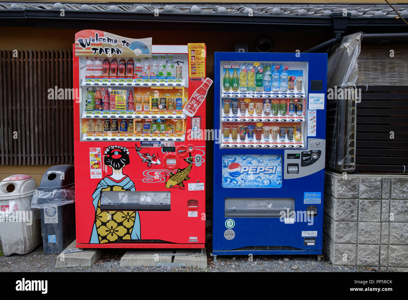 KYOTO, JAPAN - 08 FEB 2018: Coca Cola and Pepsi vending machines full of cold and hot drinks in the street competition concept Stock Photo