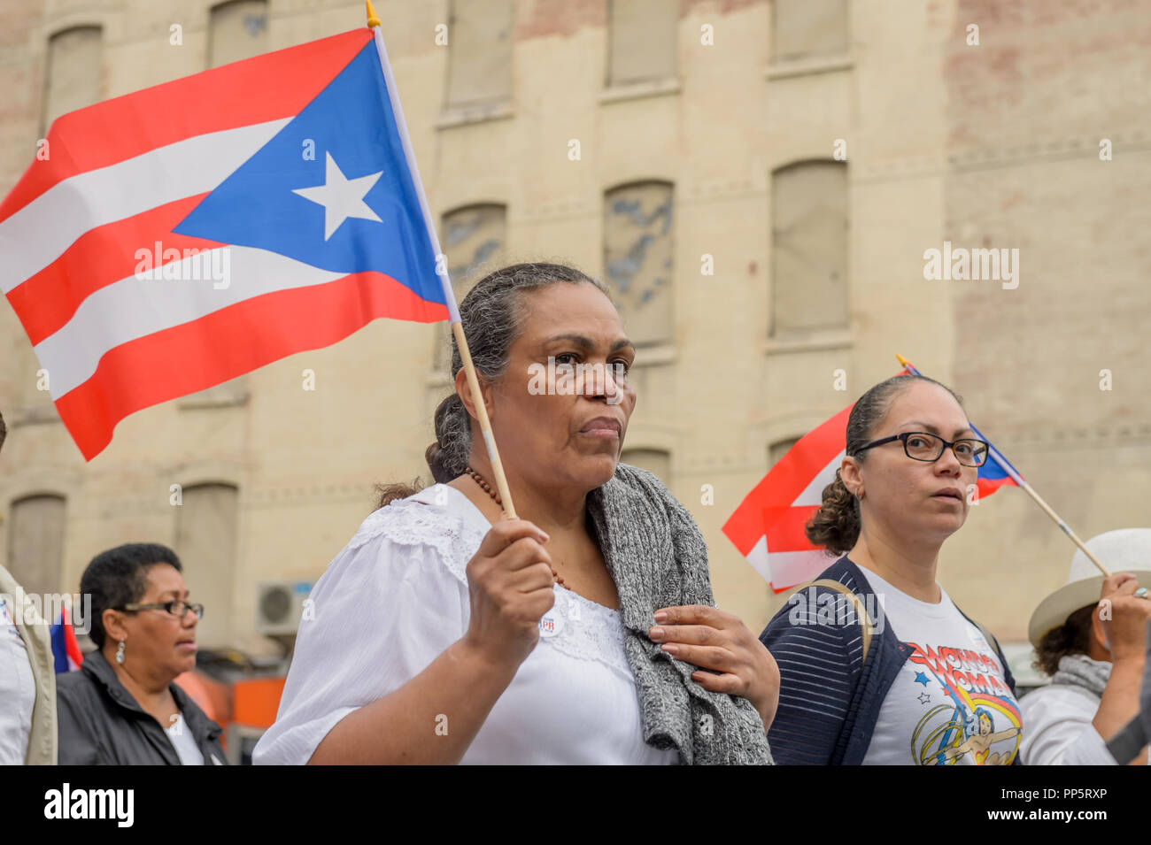 New York, United States. 23rd Sep, 2018. Hundreds of New Yorkers dressed in white participated on a silent procession through the streets of New York on September 23, 2018 to focus the nation's attention on this callous and craven neglect of U.S. Citizens in Puerto Rico still struggling for survival in the aftermath of Hurricane Maria. Participants walked 2.5 miles in unity, and in silence; from East Harlem to Trump Tower. Credit: Erik McGregor/Pacific Press/Alamy Live News Stock Photo